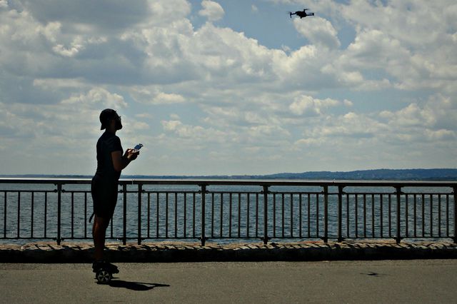 A photo of a man playing with a drone in Bensonhurst